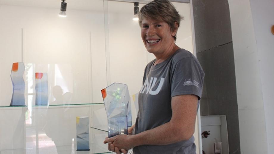 The Australian National University (ANU), Glass Workshop’s Technical Officer and Production Manager for the Australian of the Year Awards, Cathy Newton holding an Australian of the Year trophy.