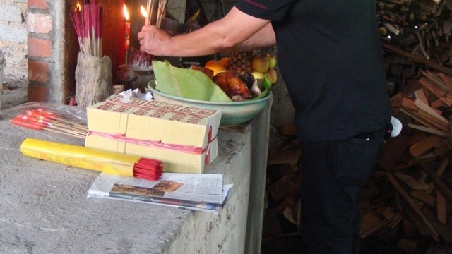 Ian Jones lighting incense at the Dragon Kiln shrine