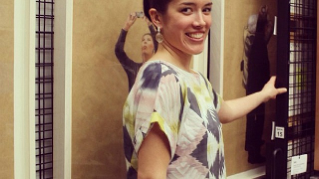 Alumni Profile Miriam Kelly pictured in front of works by Waratah Lahy